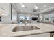 The kitchen sink in the kitchen boasts bright white cabinets, a ceiling fan, and an attached living room at 6049 Moorings S Dr, St Petersburg, FL 33712