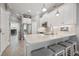 Bright kitchen featuring white cabinets, stainless steel appliances, and a stylish island with seating at 6049 Moorings S Dr, St Petersburg, FL 33712