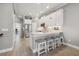 Bright kitchen featuring white cabinets, stainless steel appliances, and a stylish island with seating at 6049 Moorings S Dr, St Petersburg, FL 33712