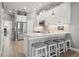 Bright kitchen featuring white cabinets, stainless steel appliances, and a stylish island with seating at 6049 Moorings S Dr, St Petersburg, FL 33712