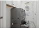 Bright laundry room with gray washer and dryer units, storage cabinets, and neutral flooring at 6049 Moorings S Dr, St Petersburg, FL 33712