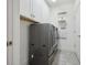 Convenient laundry room featuring a modern washer and dryer and ample white cabinetry at 6049 Moorings S Dr, St Petersburg, FL 33712