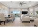 Open-concept living area showcases modern furnishings and a sliding glass door to the outside balcony at 6049 Moorings S Dr, St Petersburg, FL 33712
