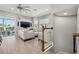 The living area offers neutral tones, a staircase, and a stylish entertainment center at 6049 Moorings S Dr, St Petersburg, FL 33712