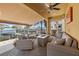 Covered patio featuring comfortable seating, a fireplace, a grill, and scenic dock views at 6049 Moorings S Dr, St Petersburg, FL 33712