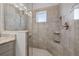 Beautiful walk-in shower with tiled walls, built-in bench, and modern fixtures at 6049 Moorings S Dr, St Petersburg, FL 33712