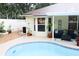 Inviting backyard with a refreshing swimming pool and a covered outdoor seating area at 810 Erik Lake Rd, Brandon, FL 33510