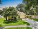 Well-maintained home with a lush front yard and driveway, showcasing its curb appeal at 810 Erik Lake Rd, Brandon, FL 33510