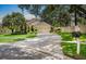 Charming single-Gathering home with a well-manicured front yard and a long, curved driveway leading to an attached two-car garage at 810 Erik Lake Rd, Brandon, FL 33510