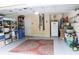 Spacious garage features storage shelves, utility access and a decorative area rug at 810 Erik Lake Rd, Brandon, FL 33510