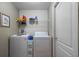 Functional laundry room with washer, dryer, and storage shelves, offering convenience at 810 Erik Lake Rd, Brandon, FL 33510