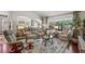 Spacious living room with comfortable seating, large windows and hardwood floors, providing a bright atmosphere at 810 Erik Lake Rd, Brandon, FL 33510