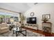 Bright living room features large windows, hardwood floors and a decorative rug at 810 Erik Lake Rd, Brandon, FL 33510