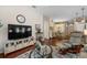 Inviting living room with hardwood floors and a large television, creating a comfortable entertainment space at 810 Erik Lake Rd, Brandon, FL 33510