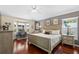 Spacious main bedroom featuring hardwood floors, a bay window, and modern decor at 810 Erik Lake Rd, Brandon, FL 33510