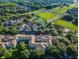 Aerial view of apartments with a nicely landscaped area and a road with light traffic nearby at 8517 Island Breeze Ln # 207, Temple Terrace, FL 33637