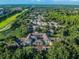 The aerial view captures the apartment complex surrounded by mature trees and a well manicured green space at 8517 Island Breeze Ln # 207, Temple Terrace, FL 33637