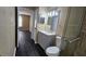 Bathroom with a gray vanity, toilet, walk-in shower, and mirror above the sink at 8517 Island Breeze Ln # 207, Temple Terrace, FL 33637