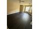 Bedroom with dark wood floors, large window with curtains, and neutral paint at 8517 Island Breeze Ln # 207, Temple Terrace, FL 33637