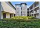 A ground level exterior shot showing well maintained landscaping around the apartment buildings at 8517 Island Breeze Ln # 207, Temple Terrace, FL 33637