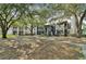 A ground level exterior shot showing buildings surrounded by mature trees and well maintained grounds at 8517 Island Breeze Ln # 207, Temple Terrace, FL 33637