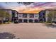 Condominium building with garages and black car parked in front during daytime with nicely landscaped yard at 8517 Island Breeze Ln # 207, Temple Terrace, FL 33637