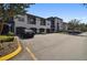 A ground level shot shows a well maintained parking area and well manicured shrubbery at 8517 Island Breeze Ln # 207, Temple Terrace, FL 33637