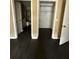 Hallway with dark wood floors showing bathroom and walk-in closet at 8517 Island Breeze Ln # 207, Temple Terrace, FL 33637