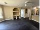 Living room with dark floors, built-in shelving, ceiling fan, and view to kitchen with countertop at 8517 Island Breeze Ln # 207, Temple Terrace, FL 33637