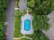 Aerial view of a refreshing pool surrounded by trees and a parking lot at 8517 Island Breeze Ln # 207, Temple Terrace, FL 33637