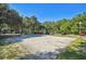 Sand volleyball court surrounded by trees and parking at 8517 Island Breeze Ln # 207, Temple Terrace, FL 33637