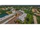 Aerial view showcasing the community's layout with lakes, mature trees, and parking at 952 Virginia St # 303, Dunedin, FL 34698