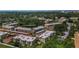 Aerial view of a well-maintained residential community with lush landscaping and a pond at 952 Virginia St # 303, Dunedin, FL 34698