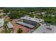 Aerial view showcasing the condo's covered parking and lush surroundings with mature trees at 952 Virginia St # 303, Dunedin, FL 34698