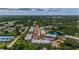 Aerial view of community showing the complex with lakes and mature trees at 952 Virginia St # 303, Dunedin, FL 34698
