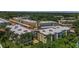Aerial shot of condo community showcasing buildings, parking, amenities, and lush landscaping at 952 Virginia St # 303, Dunedin, FL 34698