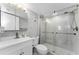 The updated bathroom features a glass shower, modern fixtures, and tiled walls at 952 Virginia St # 303, Dunedin, FL 34698