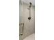 Modern bathroom with a tiled shower featuring bronze fixtures at 952 Virginia St # 303, Dunedin, FL 34698