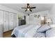 Comfortable bedroom with ceiling fan, closet, and ensuite bathroom at 952 Virginia St # 303, Dunedin, FL 34698