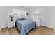 A well-lit bedroom with hardwood flooring, minimalist design, and neutral colors at 952 Virginia St # 303, Dunedin, FL 34698