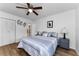 Cozy bedroom with hardwood floors, calming decor, and closet with sliding doors at 952 Virginia St # 303, Dunedin, FL 34698