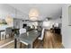 Open dining room with modern lighting adjacent to the kitchen and living spaces at 952 Virginia St # 303, Dunedin, FL 34698