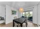 Bright dining area with wood-look floors and a sliding glass door to the lanai at 952 Virginia St # 303, Dunedin, FL 34698