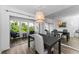 The dining room features modern lighting, a mirror accent wall, and sliding door at 952 Virginia St # 303, Dunedin, FL 34698