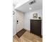 Inviting entryway featuring wood-look floors and a dark wood storage cabinet with decor at 952 Virginia St # 303, Dunedin, FL 34698