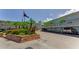 View of condo exterior with parking and landscaping, plus American flag at 952 Virginia St # 303, Dunedin, FL 34698