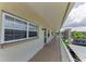 Exterior hallway featuring a security door, windows, and a well maintained walkway at 952 Virginia St # 303, Dunedin, FL 34698