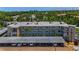 Exterior shot showcasing condo, parking, and lush surroundings, offering a serene living environment at 952 Virginia St # 303, Dunedin, FL 34698