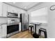 Bright kitchen featuring modern appliances, white cabinets, and a small eating area at 952 Virginia St # 303, Dunedin, FL 34698