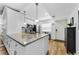 Updated kitchen featuring stainless appliances, a granite island and sleek cabinets at 952 Virginia St # 303, Dunedin, FL 34698